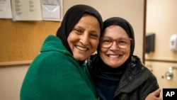 Bibi Bahrami and her close friend Dr. Miriam Ibrahim embrace at the Islamic Center of Muncie, Ind., March 3, 2023. Bahrami is a subject of the documentary "Stranger at the Gate."