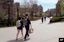 FILE - Students walk on the campus of Boston College, Monday, April 29, 2024, in Boston, Massachusetts. (AP Photo/Charles Krupa, File)