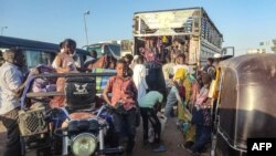 People displaced by the conflict in Sudan flee Wad Madani, the capital of al-Jazirah state, heading to Gadaref state on Dec. 16, 2023. 