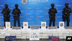 Police officers stand behind seized crystal methamphetamine during a news conference in Bangkok, Thailand, May 29, 2023.