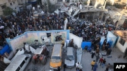 Palestinians inspect debris after an Israeli strike near a United Nations Relief and Works Agency for Palestine Refugees (UNRWA) school in Khan Yunis, in the southern Gaza Strip, Oct. 21, 2023. 