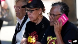 FILE - Indigenous women sit at a polling place in Redfern as Australians cast their final votes in Sydney, Oct. 14, 2023, in their first referendum that aims to tackle Indigenous disadvantage by enshrining in the constitution a new advocacy committee. 