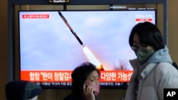 A TV screen shows a file image of a North Korean missile launch during a news program broadcast at the Seoul Railway Station in Seoul, South Korea, Feb. 24, 2023. 