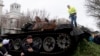 The wreck of a Russian T-72 tank destroyed on the approach to Kyiv is placed in front of the Russian Embassy to mark the first anniversary of Russia's full-scale invasion of Ukraine, in Berlin, Feb. 24, 2023.