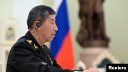 FILE - Chinese Defense Minister Li Shangfu attends a meeting with Russian President Vladimir Putin and Defense Minister Sergei Shoigu in Moscow, April 16, 2023. Sputnik/Pavel Bednyakov/Pool via Reuters.