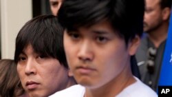 FILE - Ippei Mizuhara stands next to Japanese baseball star Shohei Ohtani and translates during an interview at Dodger Stadium on Feb. 3, 2024.