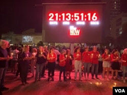 位处特拉维夫市中心广场设有一个超大型LED红色字幕看板上显示人质从被俘到当前的实况计时，提醒民众人质危机已近22天。(美国之音/赖素芬)