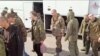 A still image from video, released by Russia's Defense Ministry April 10, 2023, shows what it claims to be Russian service personnel boarding a bus following an exchange of prisoners of war between Russia and Ukraine, at an unidentified location.
