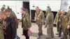 Sebuah gambar yang dirilis oleh Kementerian Pertahanan Rusia, menunjukkan sejumlah personel militer Rusia yang naik bus pasca pertukaran tawanan perang di lokasi yang tidak diketahui, diambil dari rekaman video yang dirilis Senin, 10 April 2023.