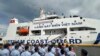 Philippine Coast Guard personnel wave Vietnamese and Filipino flags to welcome the Vietnam Coast Guard ship CSB 8002 in Manila, Philippines, Aug. 5, 2024.