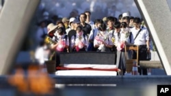 Visitors pray in front of the cenotaph dedicated to the victims of the atomic bombing at the Hiroshima Peace Memorial Park in Hiroshima, western Japan, Aug. 6, 2023.