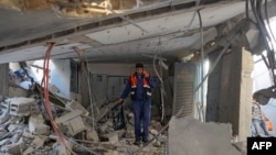 A Palestinian worker walks amid debris at a water desalination plant that was hit during a strike in Nuseirat in the central Gaza Strip on June 7, 2024.