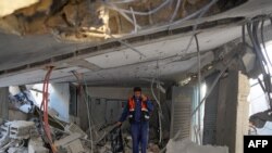 গাজার মধ্যাঞ্চলে নুসেইরাতে ধর্মঘটের সময় আঘাত হানা একটি জল লবণমুক্ত করার স্থাপনায় ধ্বংসাবশেষের মধ্যে একজন ফিলিস্তিনি শ্রমিক হাঁটছেন। ৭ জুন, ২০২৪। 