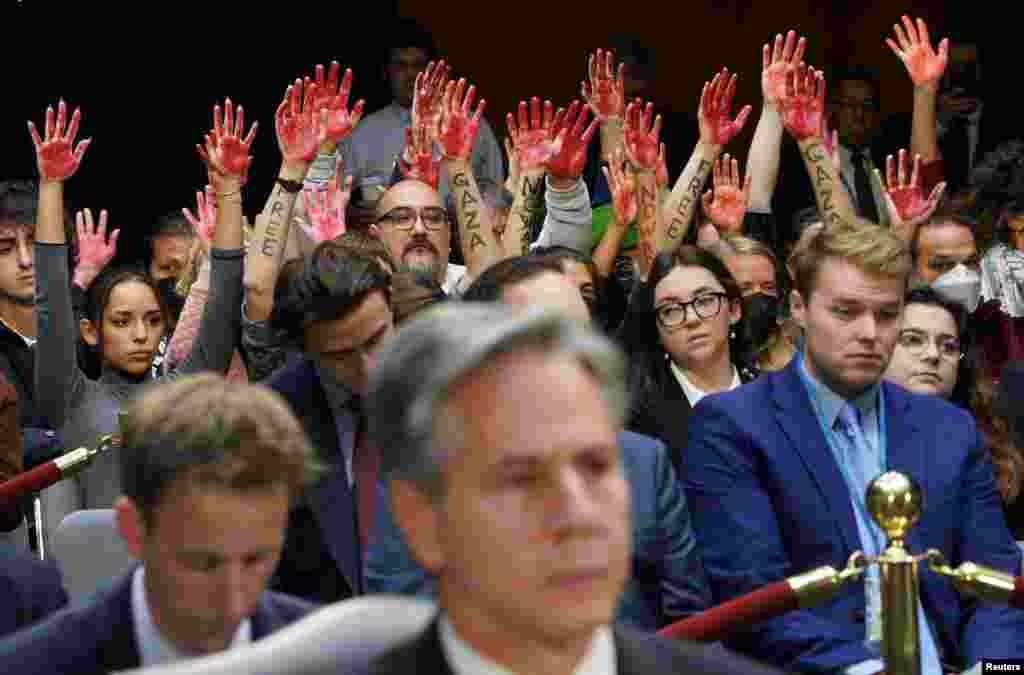 Anti-war protesters raise their &quot;bloody&quot; hands behind U.S. Secretary of State Antony Blinken during a Senate Appropriations Committee hearing on President Biden&#39;s $106 billion national security supplemental funding request to support Israel and Ukraine, as well as bolster border security,&nbsp;on Capitol Hill in Washington, Oct. 31, 2023.
