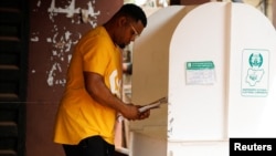 A man prepares to cast his vote during Nigeria's Presidential election in Agulu, Anambra state, Nigeria, Feb. 25, 2023.