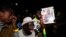 Supporters of Senegalese presidential candidate Bassirou Diomaye Faye celebrate early results showing that Faye is leading initial presidential election tallies, in Dakar, Senegal, March 24, 2024. 