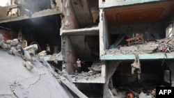 Palestinians children search through the rubble of their home a day after an operation by the Israeli Special Forces in the Nuseirat camp, in the central Gaza Strip on June 9, 2024.