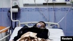 FILE - A young woman lies in hospital after reports of poisoning at an unspecified location in Iran in this still image from video from March 2, 2023. (WANA/Reuters TV via Reuters)