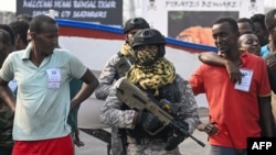 Accused Somali pirates wait to be transferred to police custody as Indian naval commandos stand guard at the dockyard in Mumbai on March 23, 2024. 