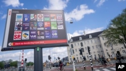Bicyclists pass a billboard for the European Election outside the Maritime Museum in Amsterdam, the Netherlands, June 5, 2024. Voters in the European Union are set to elect lawmakers starting June 6 for the bloc's parliament.