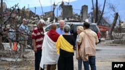 U.S. President Joe Biden and first lady Jill Biden speak with Lahaina elders at Moku'ula following wildfires in Lahaina, Hawaii, on August 21, 2023. (AFP/Mandel NGAN)