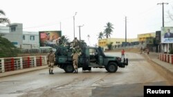 Soldiers of the Republican Guard stand on their armed pick-up in a street in Libreville, Gabon, Aug. 30, 2023.
