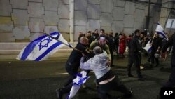 Israeli police scuffle with demonstrators blocking a highway during a protest against plans to overhaul the judicial system in Tel Aviv, Israel, March 25, 2023.