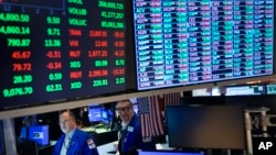 Traders work on the floor at the New York Stock Exchange in New York, Jan. 23, 2024.
