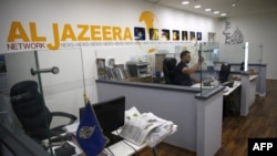 FILES - An employee of the Qatar-based news network and TV channel Al-Jazeera is seen at the channel's Jerusalem office, July 31, 2017. Israel's Prime Minister said on May 5, 2024, that his government has decided to shut down Al Jazeera.