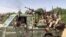 FILE - Fighters ride in the back of a pickup truck mounted with a turret in the East Nile district of greater Khartoum, in this image grab taken from handout video footage released by the Sudanese paramilitary Rapid Support Forces on April 23, 2023.