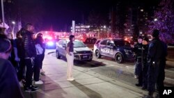 Students get directions from police on the campus of Michigan State University after a shelter in place order was lifted early Tuesday, Feb. 14, 2023, in East Lansing, Mich.