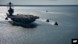 FILE - In this photo provided by the U.S. Navy, the USS Gerald R. Ford embarks on its first sea trial from Newport News, Virginia, April 8, 2017. (Mass Communication Specialist 2nd Class Ridge Leoni/U.S. Navy via AP)