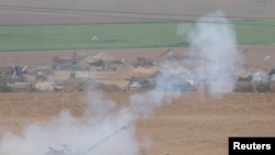 Israeli artillery unit fires from the Israeli side of the Israel Gaza border into Gaza, as the conflict between Israel and the Palestinian Islamist group Hamas continues, near the Israel-Gaza border, Oct. 29, 2023.