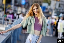Iris Mozalar, 24, a trans woman who is also an LGBTI+ rights activist poses on Galata bridge in Istanbul, Turkey, June 25, 2024.