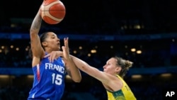 Gabby Williams (15), of France, shoots over Steph Talbot (6), of Australia, in a women's basketball game at the 2024 Summer Olympics, in Villeneuve-d'Ascq, France, Aug. 4, 2024.