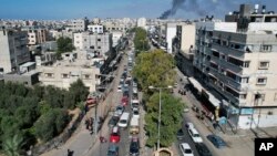 Palestinians flee from northern Gaza to the south after the Israeli army issued an unprecedented evacuation warning to a population of over 1 million people to seek refuge ahead of a possible Israeli ground invasion, Oct. 13, 2023. 