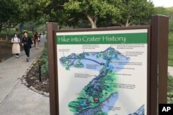 People walk down a pathway at the Diamond Head State Monument in Honolulu, on Jan. 16, 2018. (AP Photo/Eric Risberg)