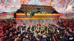 Shiite Muslims participate in the Arbaeen pilgrimage in Karbala, Iraq, Aug. 25, 2024. 