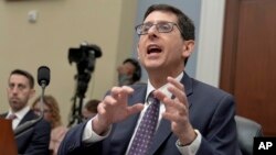 FILE - Phillip Swagel, Director of the Congressional Budget Office, testifies during a House committee hearing in Washington, Feb. 14, 2024. The CBO said June 18 that it projects a federal budget deficit increase of 27% this year from its last budget outlook released in February.