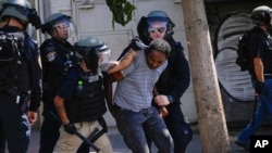 Eritrean protesters clash with Israeli riot police in Tel Aviv, Sept. 2, 2023. Hundreds of Eritrean asylum seekers smashed shop windows and police cars in Tel Aviv on Saturday and clashed with police.