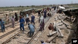 Workers repair a railway track at the site of Sunday's train derailment, near Nawabshah, a district of Pakistan's southern Sindh province, Aug. 7, 2023. 
