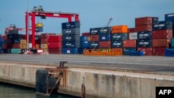 FILE - Containers are stacked up at the Port of Cotonou in Benin, May 28, 2019. A Millennium Challenge Corporation grant crafted in 2023 will focus on reducing transportation costs between the port and Niamey, Niger.