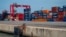 FILE - Containers are stacked up at the Port of Cotonou in Benin, May 28, 2019. A Millennium Challenge Corporation grant crafted in 2023 will focus on reducing transportation costs between the port and Niamey, Niger.