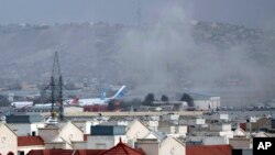 FILE - Smoke rises from a deadly explosion outside the airport in Kabul, Afghanistan, Aug. 26, 2021.