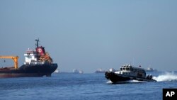 FILE - A boat with Russian, Ukrainian, Turkish and U.N. officials heads to inspect cargo ships coming from Ukraine loaded with grain, in the Marmara Sea in Istanbul, Turkey, Oct. 1, 2022