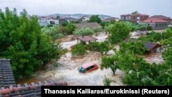 A car is submerged under water during a storm on mount Pelion, near Volos, Greece, Sept. 5, 2023. 