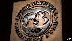 FILE - The logo of the International Monetary Fund is visible on its building in Washington, April 5, 2021. An IMF delegation began reviewing Pakistan’s current loan program on March 14, 2024.