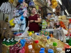 Charina Em poses in one of her food stores in Manila on Thursday, Sept. 21, 2023. (AP Photo/Joeal Calupitan)