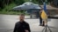 Ukraine's President Volodymyr Zelenskyy answers media questions standing against the backdrop of an F-16 fighter jet at an undisclosed location in Ukraine, Aug. 4, 2024.