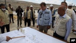 UN Deputy Regional Humanitarian Coordinator for the Syria Crisis David Carden, center, inspects a wastewater treatment project in the village of Bhora, in Idlib province, Syria, May 14, 2024.
